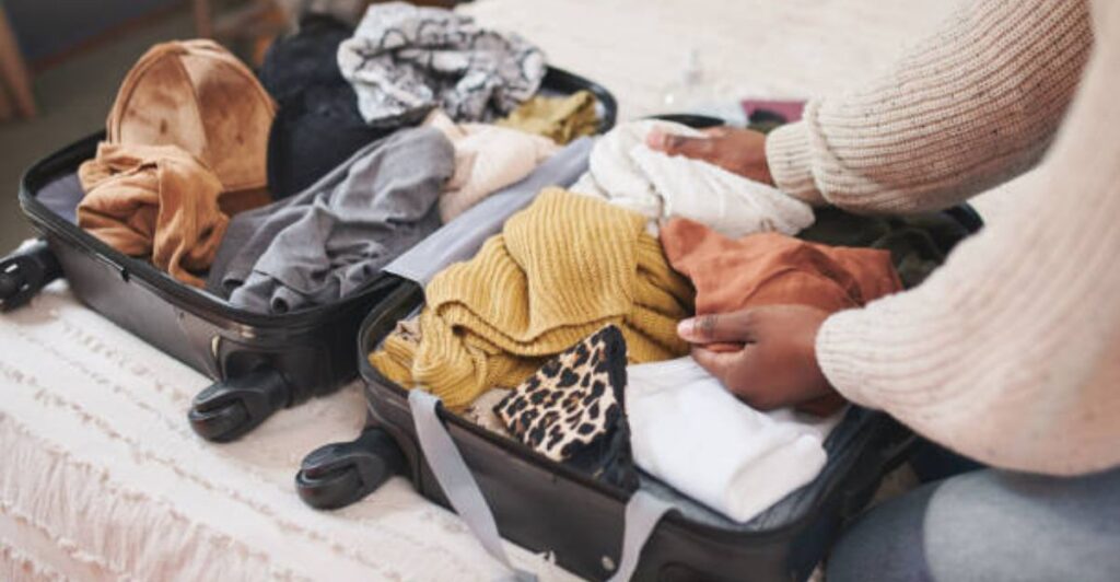 Traveler packing efficiently with clothes neatly arranged for a stress-free trip