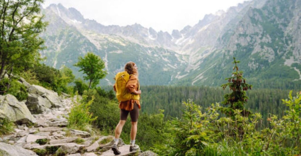Backpacker exploring mountains on a budget-friendly and stress-free adventure trip