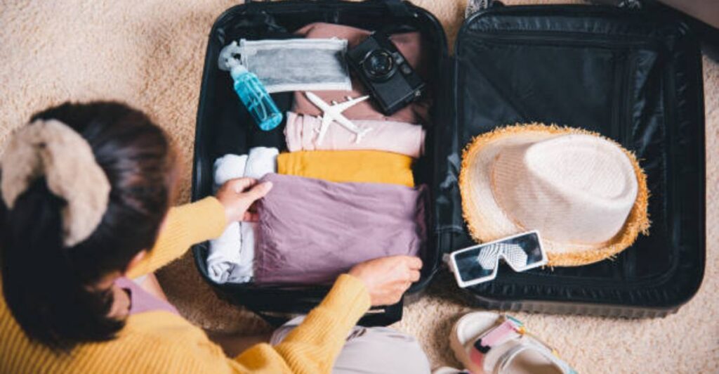 Minimalist packing technique showing neatly folded clothes and travel items