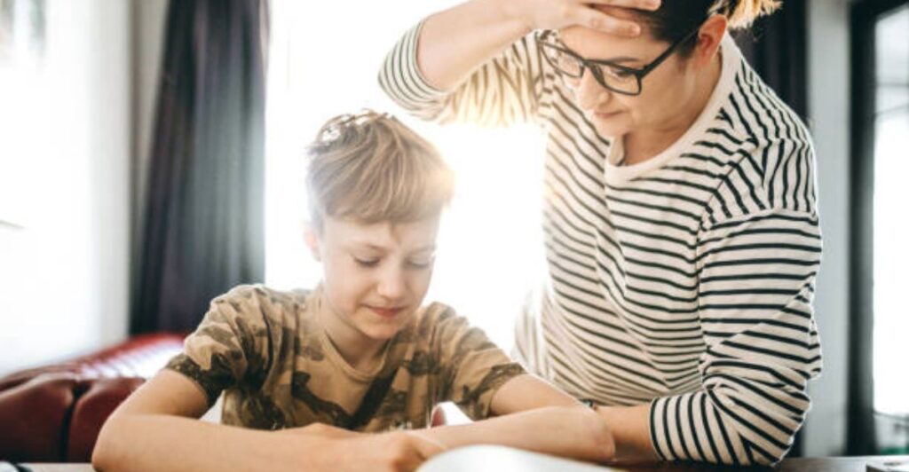 Child writing affirmations like “I can improve my writing” in a notebook