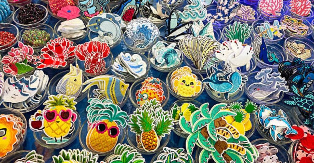 Tropical summer party table decorated with handmade hibiscus crafts, seashell ornaments, and colorful drink stirrers.