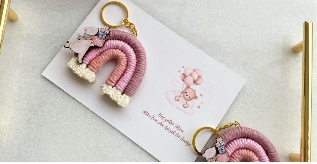 Tiny embroidery hoop keychain with floral hand-stitched pattern and rustic style.