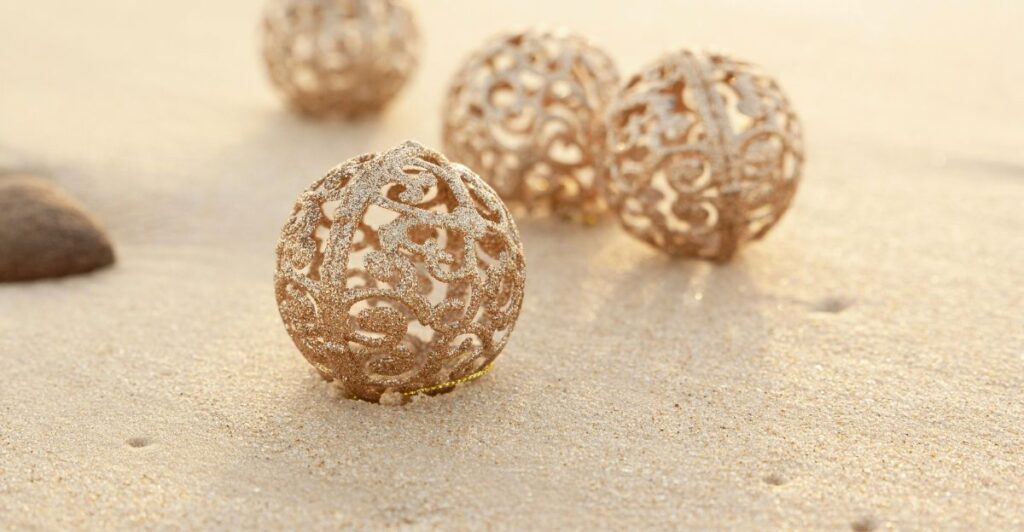 Handmade aquarium decorative balls with colorful marine designs displayed near a soft sofa and candles.