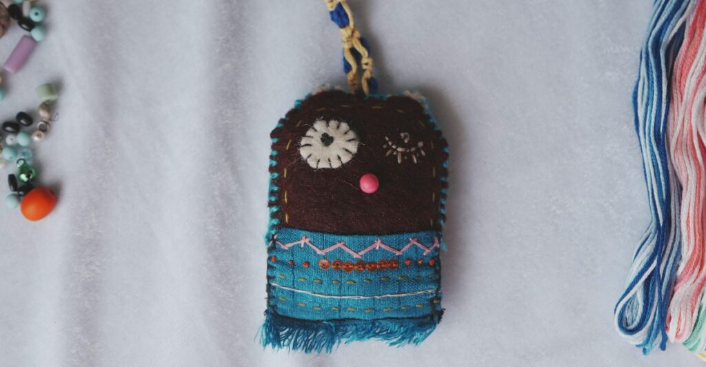 Personalized beaded name keychain with colorful alphabet beads and charms.