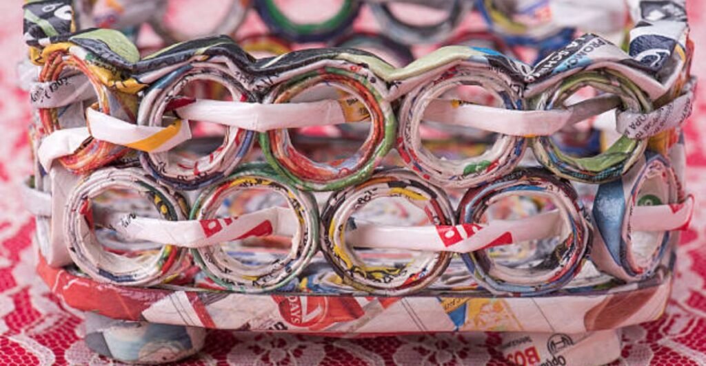 Colorful handmade storage basket woven from recycled magazine paper rolls for eco-friendly home organization.