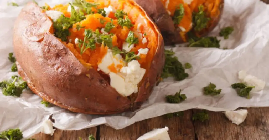 Oven-baked stuffed bell peppers topped with melted cheese and fresh parsley on a serving plate.