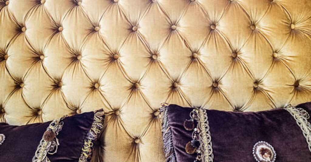 Luxury bedroom decorated with gold accents and velvet furnishings