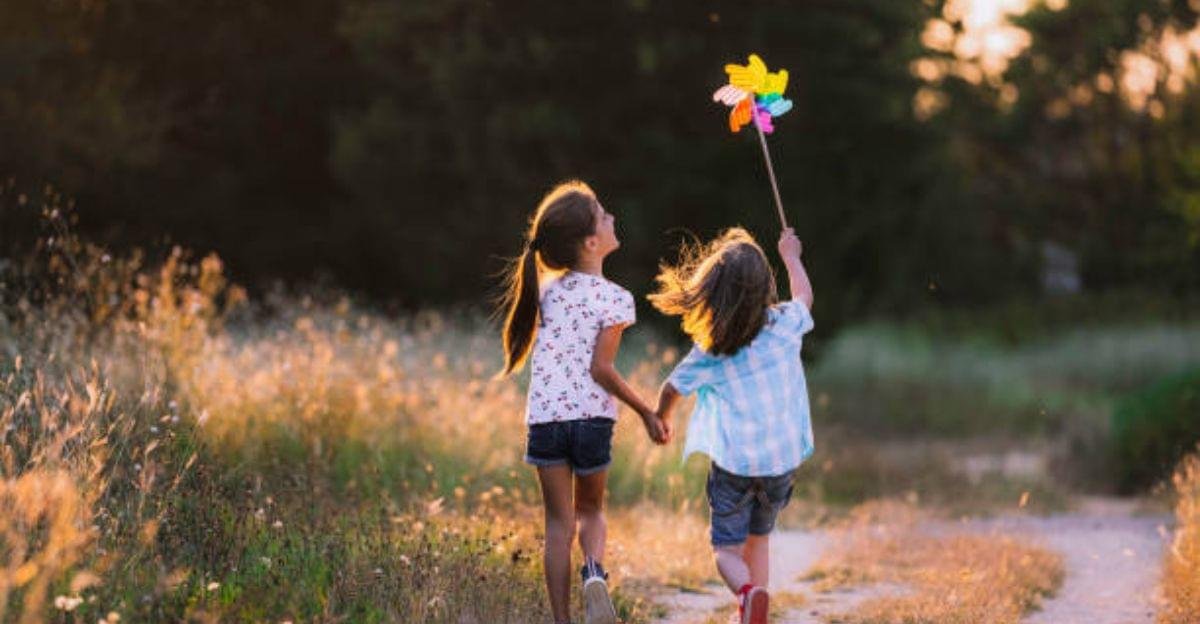 Siblings sharing hugs and laughter during a playful backyard photo session.