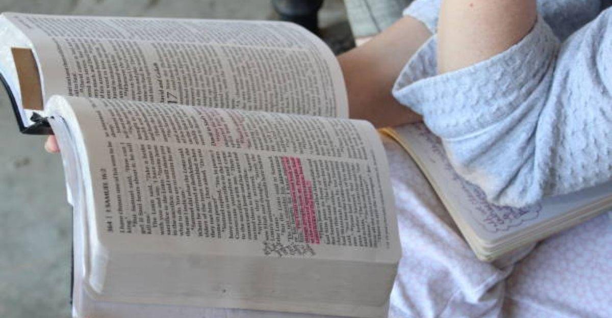 A person reading the Holy Bible during a peaceful morning prayer with sunlight streaming through the window.