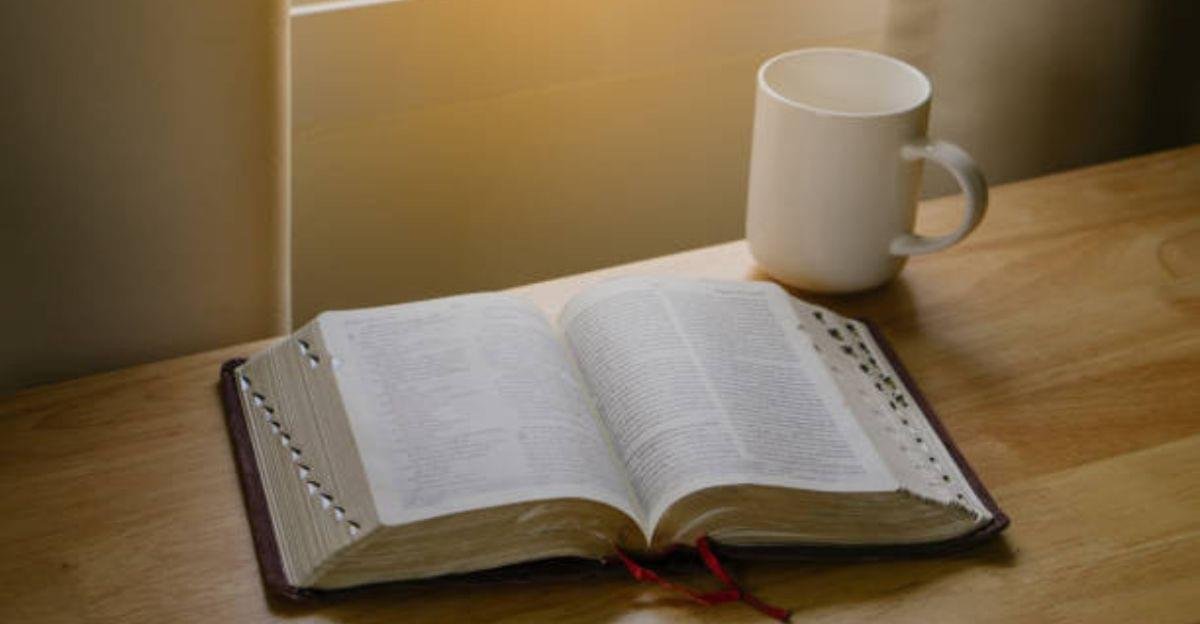An open Bible beside a cup of coffee and a notebook used for daily scripture journaling and reflection.